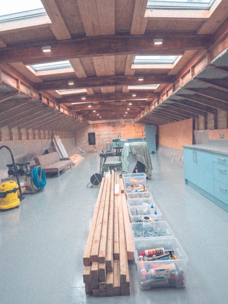 Long barge interior with overhead beams and skylights during fit-out