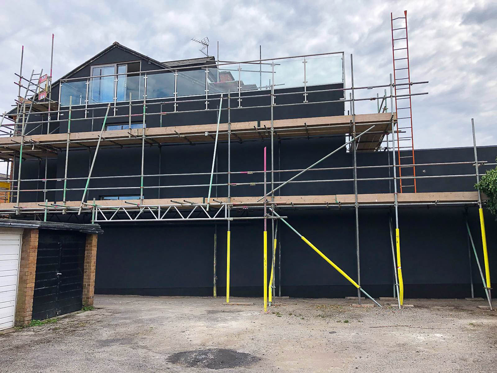 Scaffolding in place across the Harborne side elevation during the exterior cork installation