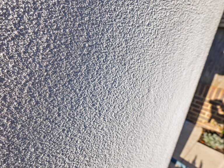 Close-up of the textured off-white spray cork finish at Hove