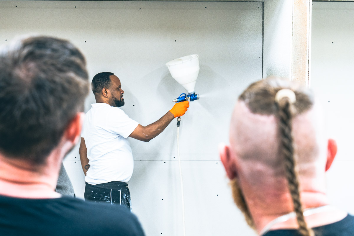 Trainer demonstrating spray cork application to a small group at the ECOPROCORK Academy