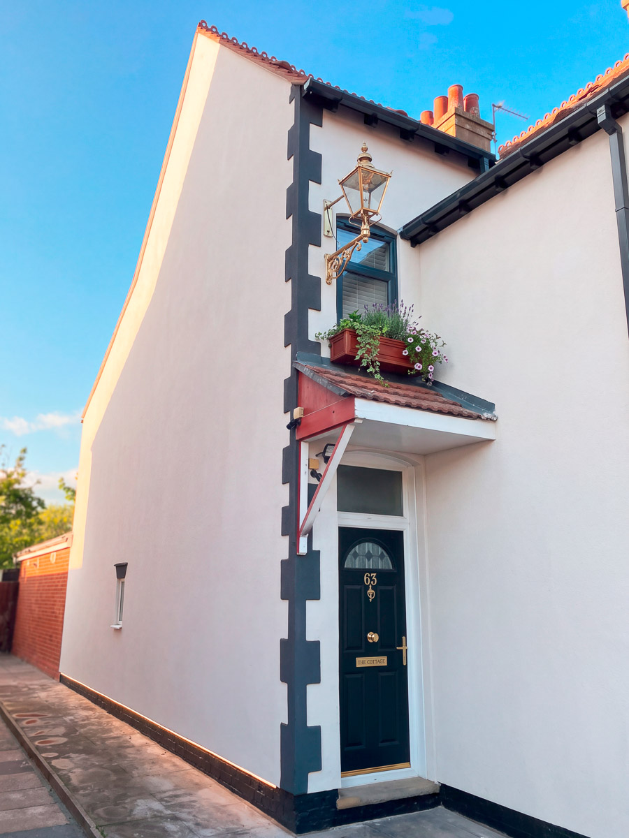 Traditional house after renovation, with a fresh light exterior and dark detailing