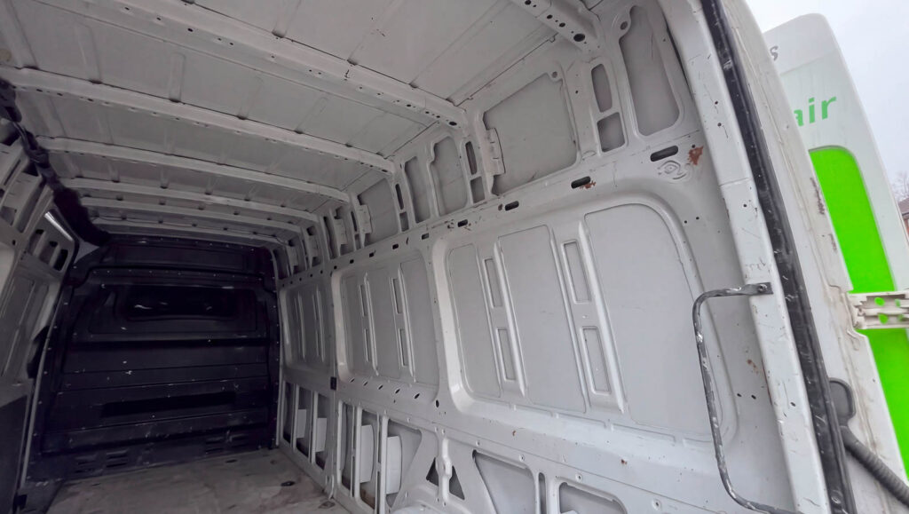 Unlined van interior showing roof ribs and side panels