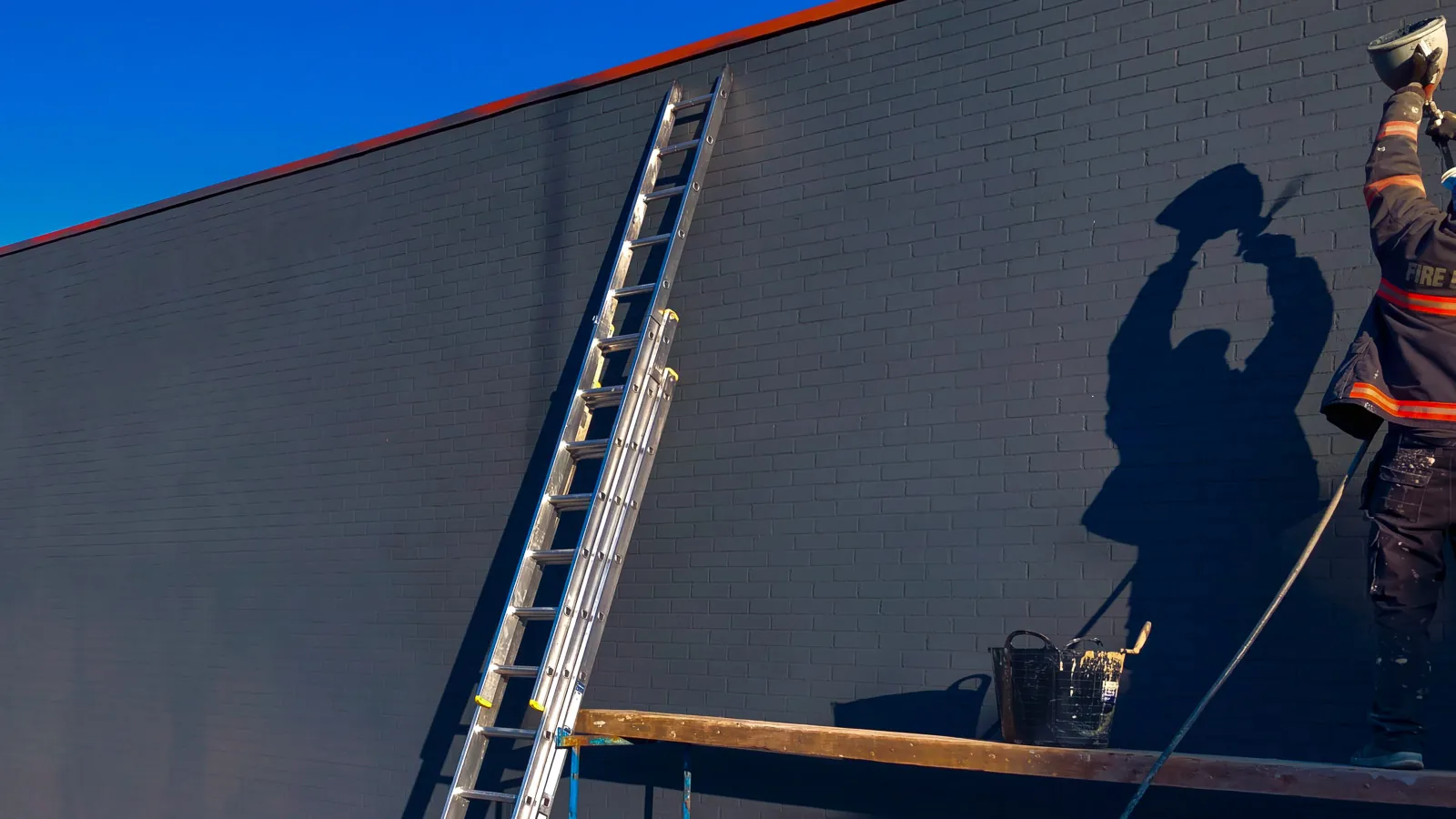 Spray cork being applied to the factory wall