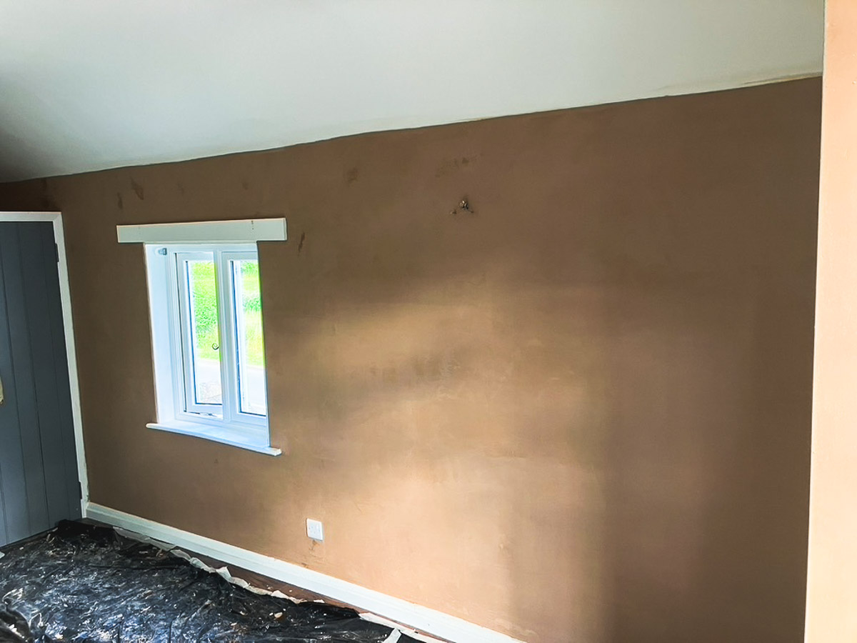 Internal wall beside a window with the floor protected during refurbishment