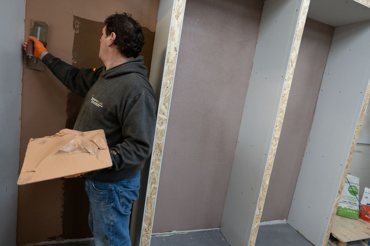 Applying the final plaster skim to the Academy wall bay